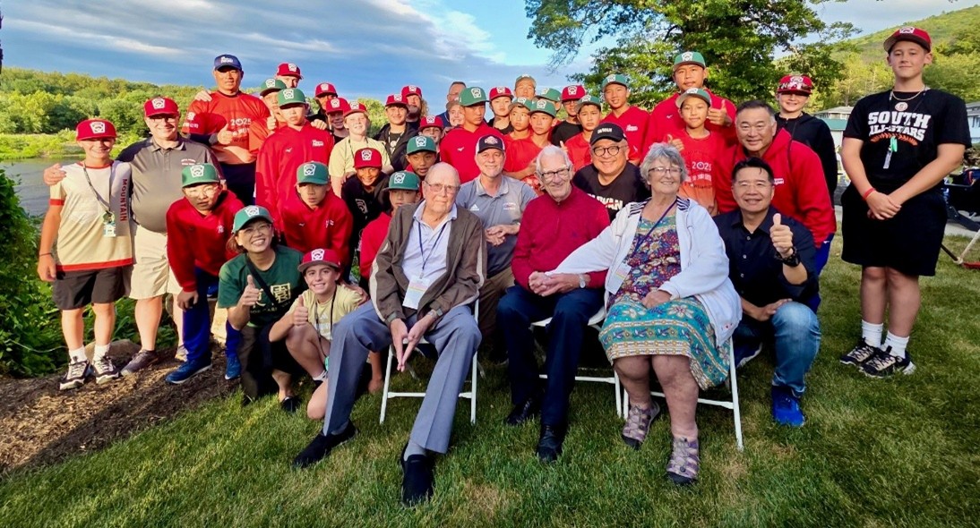 Overlooking the west branch of the Susquehanna River, Rep. Jamie Flick (R-Lycoming/Union) is pictured with players from Chinese Taipei (Team Asia-Pacific) and Nevada (Team Mountain Region), team families and coaches. Seated left to right are Billy Martin, who pitched the World Series' first no-hitter in 1950, Donald "Doc" Shearer, who played for Montoursville Little League in the very first tournament in 1947, and Karen Stotz Myers, daughter of Carl Stotz, founder of Little League.